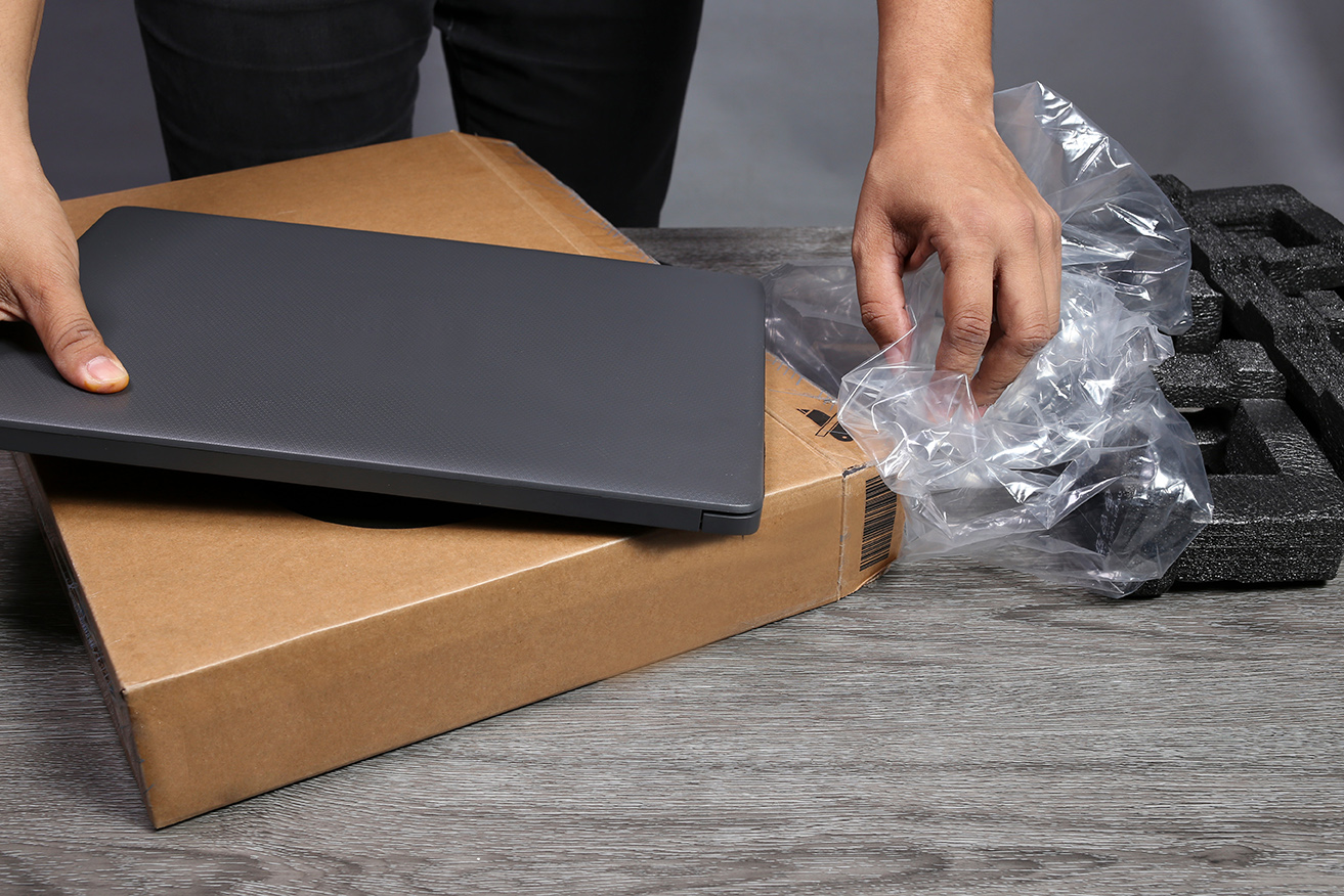 Man's,Hands,Taking,A,New,Laptop,Out,Of,Its,Cardboard